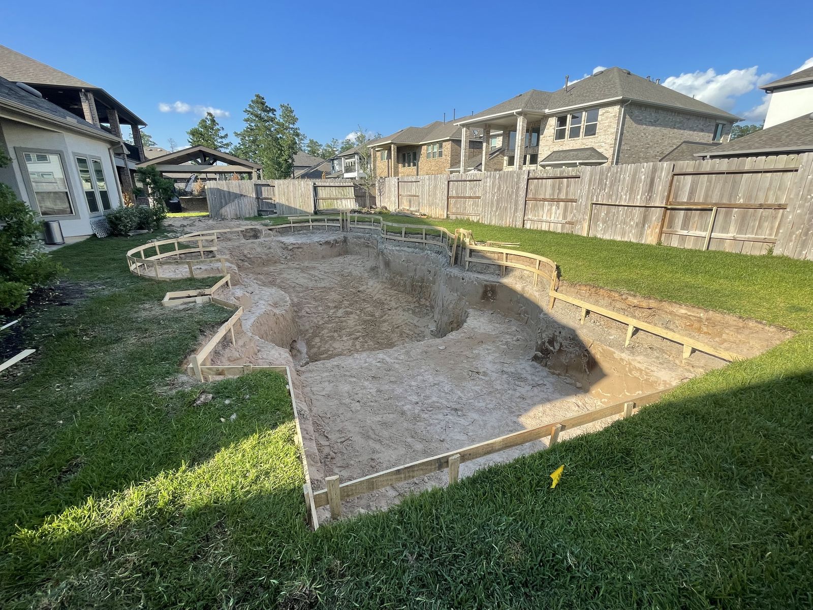 Excavated freeform pool with forms around the edge