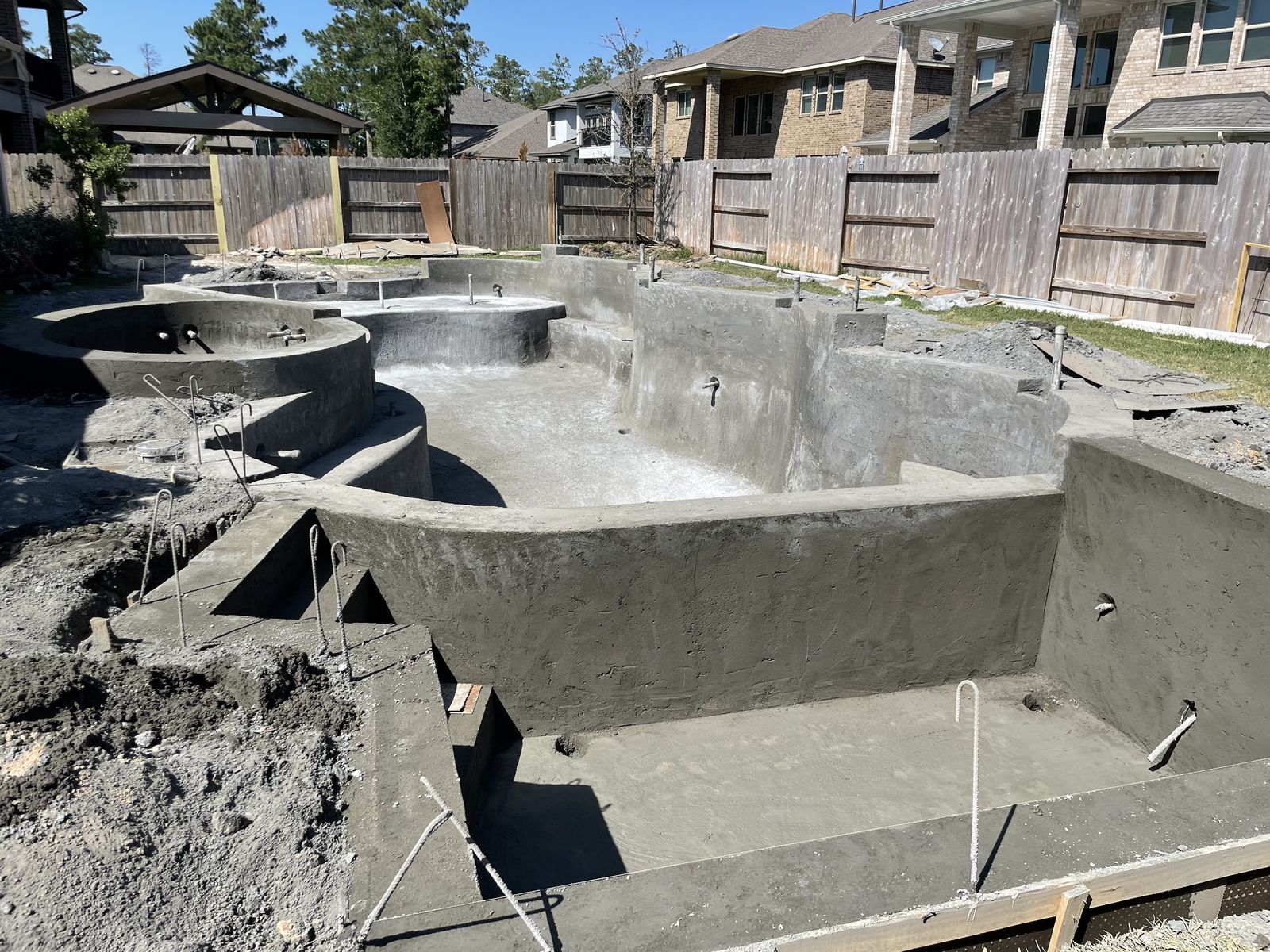 Finished gunite pool shell with spa and benches