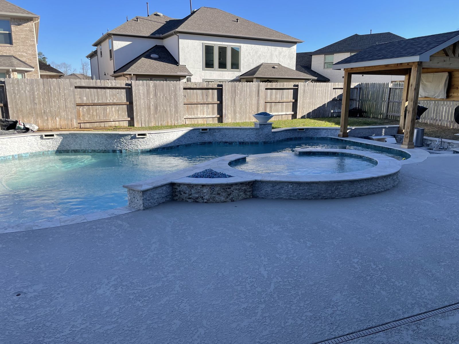 Freeform pool with spa and pergola