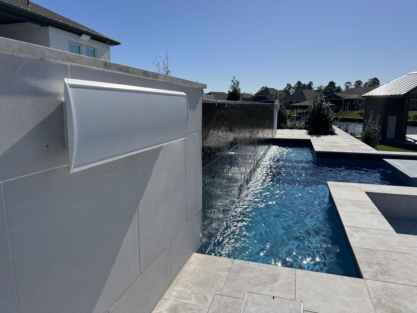 Sheer water wall spilling into a pool