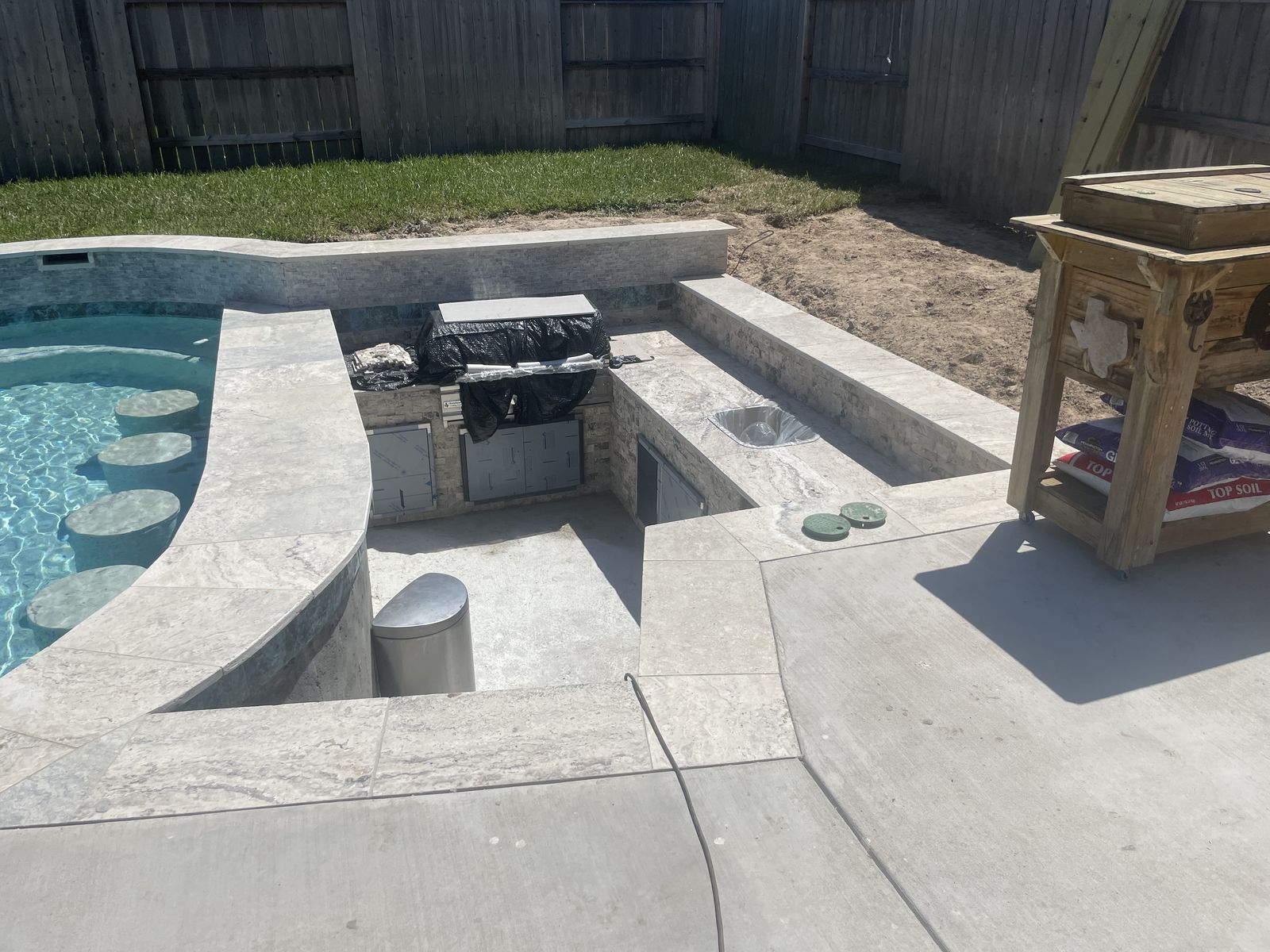 Sunken outdoor kitchen and swim-up bar close to finish