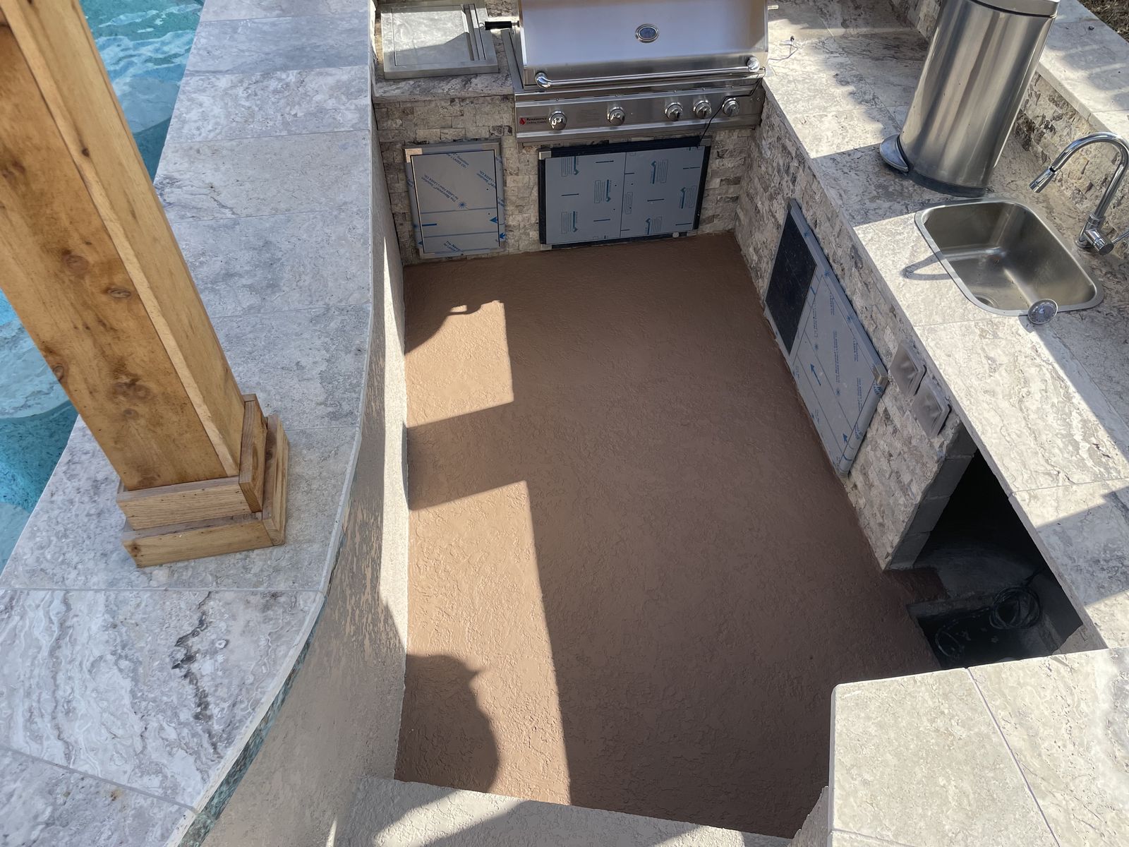 Sunken outdoor kitchen with grill and sink